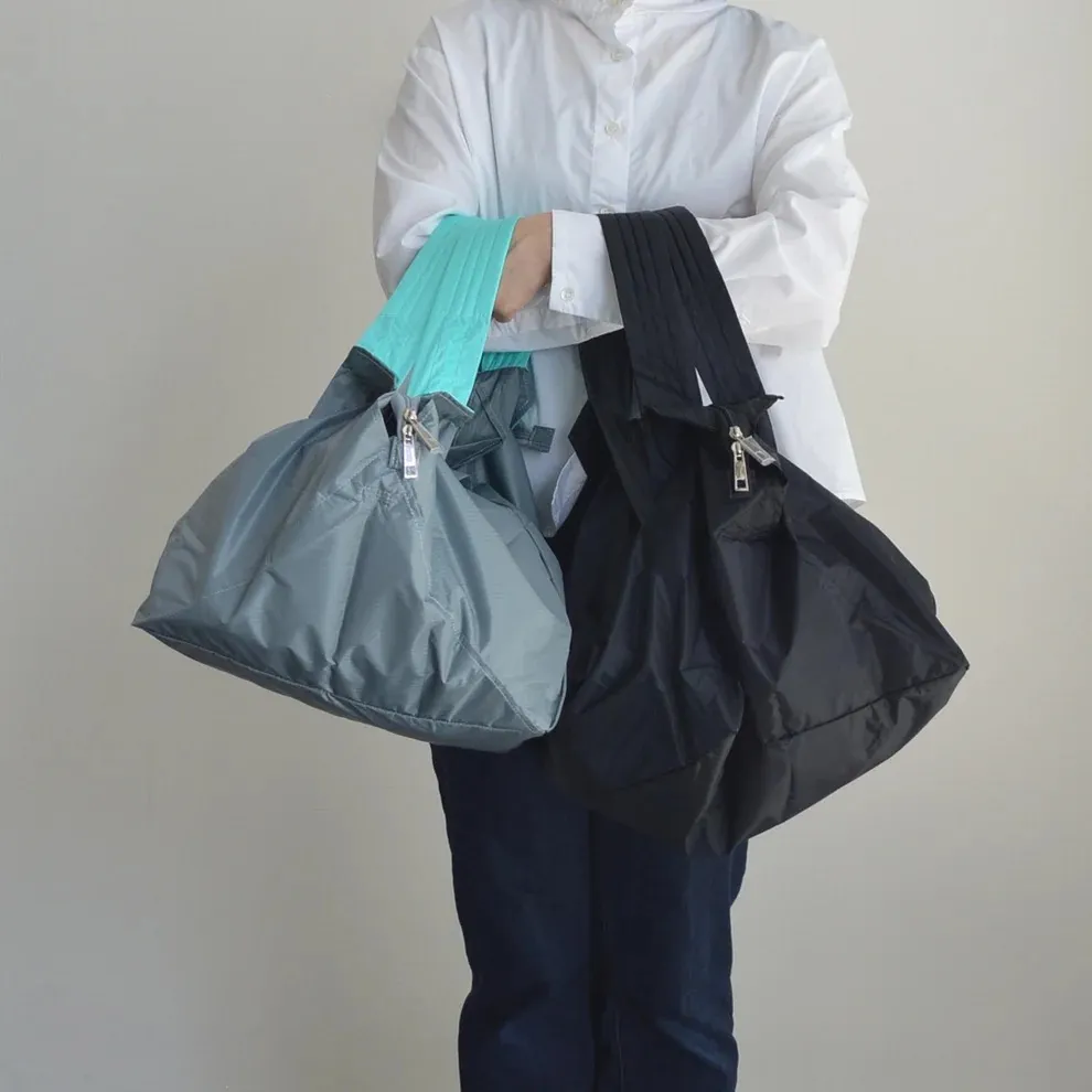 Folded insulated shopping bag inside everyday handbag